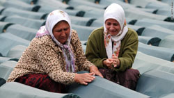 Bosnian Muslim women weep among coffins displayed at the memorial center of Potocari near Srebrenica.
